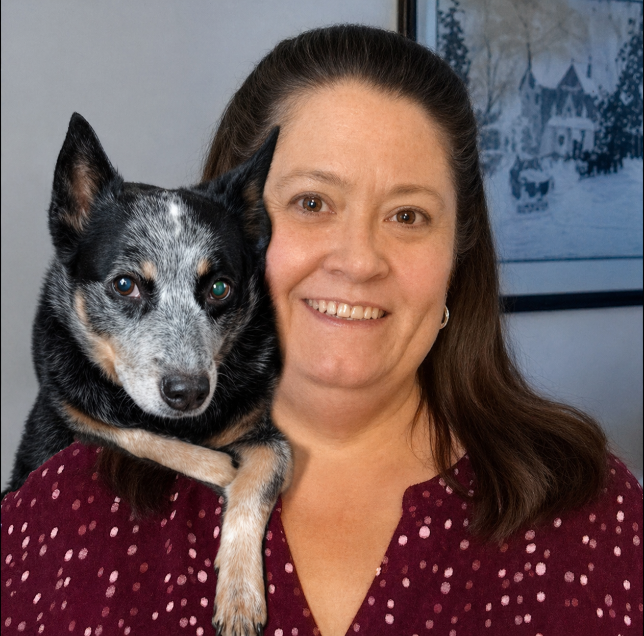 Woman smiling with an Australian Cattle Dog on her shoulder